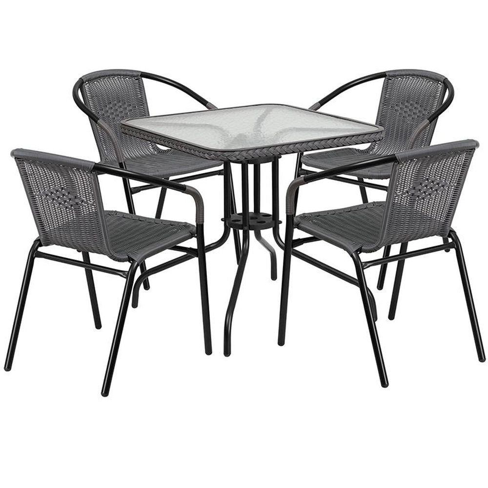 28 inch square glass metal table with rattan edging and 4 rattan stack chairs