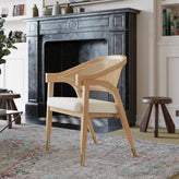 Naomi Commercial Cane Rattan Dining and Accent Chair with Solid Wood Frame Featuring Gold Tipped Legs and Beige Padded Seat in Natural