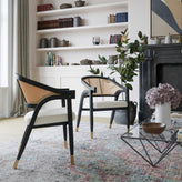 Naomi Commercial Cane Rattan Dining and Accent Chair with Solid Wood Frame Featuring Gold Tipped Legs and Beige Padded Seat in Natural/Black