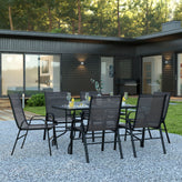Brazos 7 Piece Outdoor Patio Dining Set - 55" Tempered Glass Patio Table with Umbrella Hole, 6 Black Flex Comfort Stack Chairs